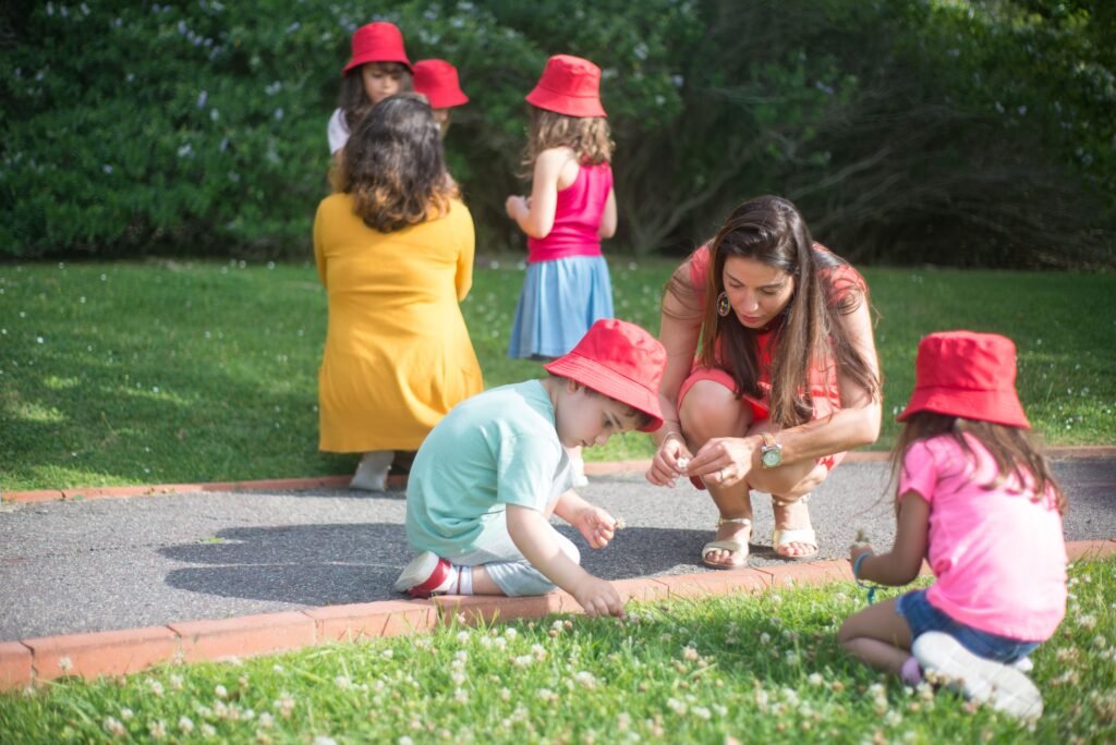 preschool children observing birds and insects outdoors