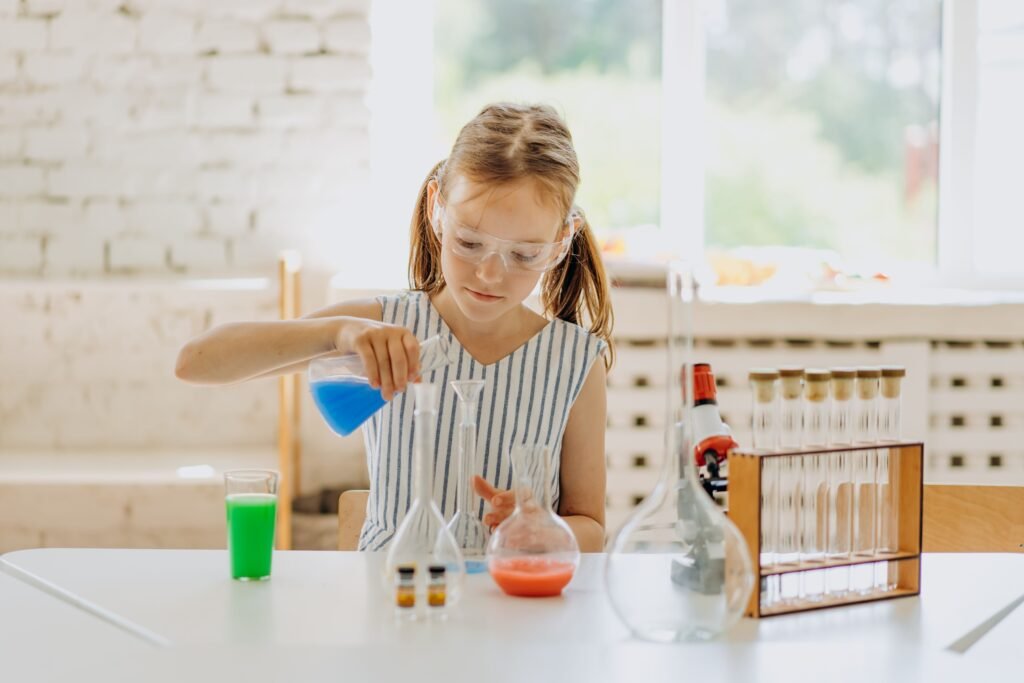 Preschool child performing a simple STEM science experiment