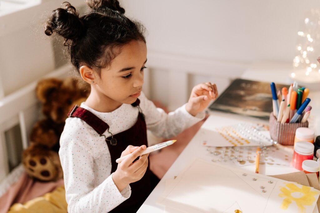 Preschooler using activity books for learning and creative play